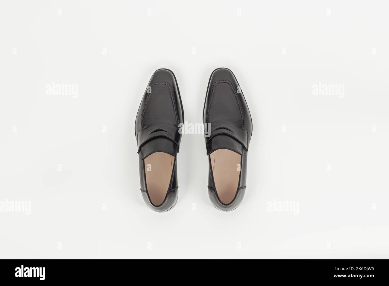 Beautiful black leather male fashion penny loafer isolated on white background top view Stock Photo
