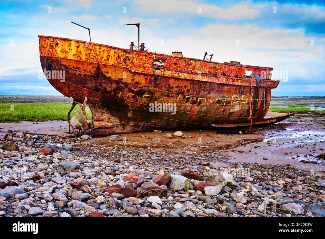 A rusty shipwreck in the mud of the Walney Channel in Roa Island, Cumbria, England, UK Stock Photo