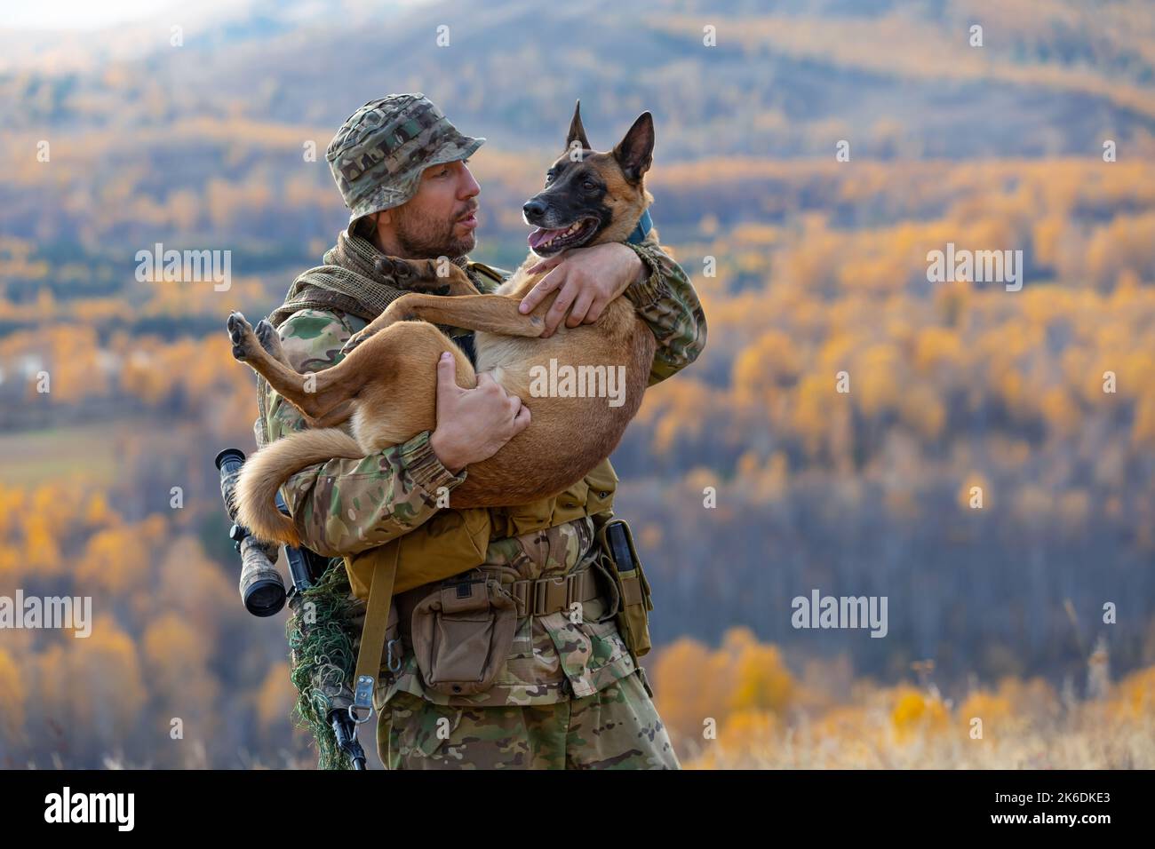 Best friends. The soldier is holding his faithful friend in his arms