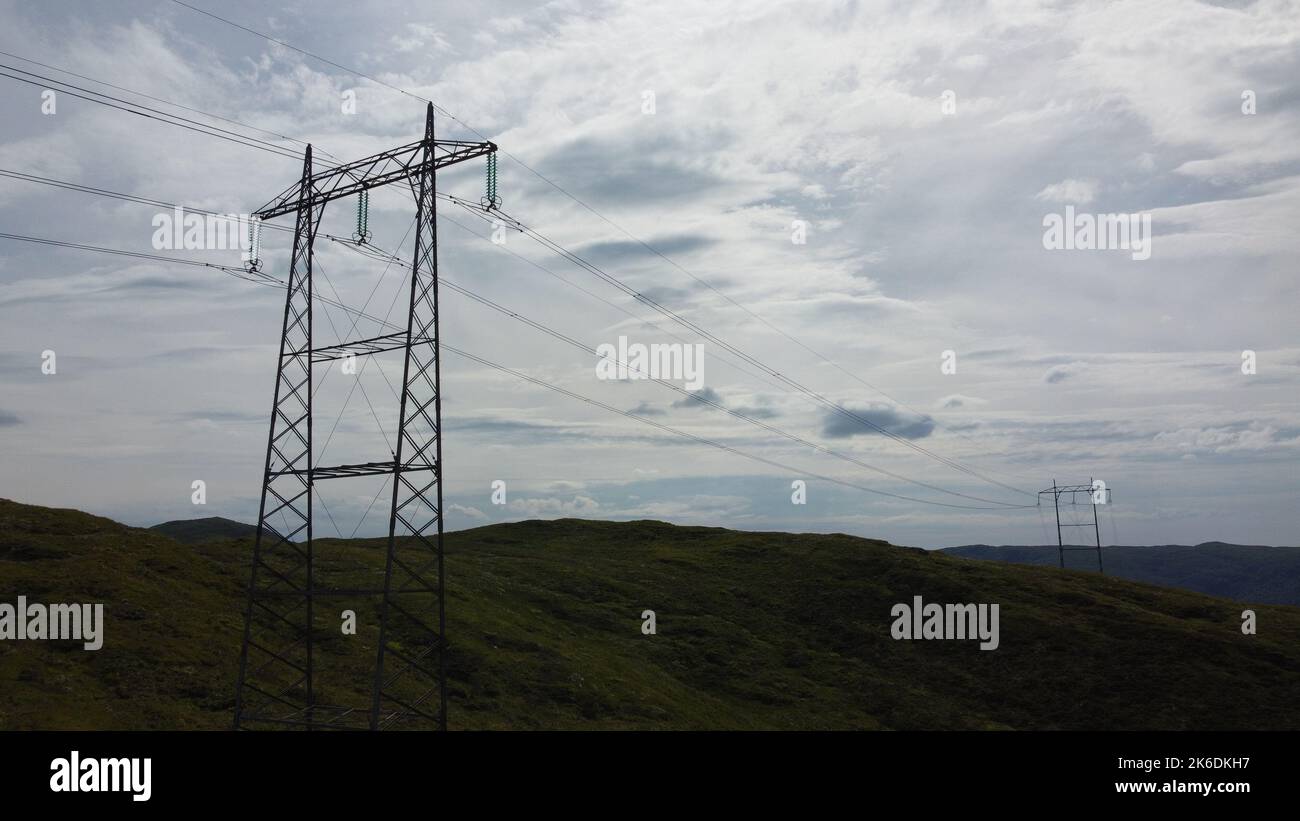 A power line on the hill covered in greenery Stock Photo - Alamy