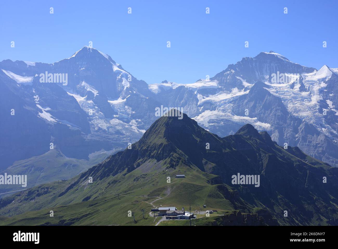 Curated visual reference: Fresh Look at An Aerial View Of Buildings On Steep Mountain With Snowcap