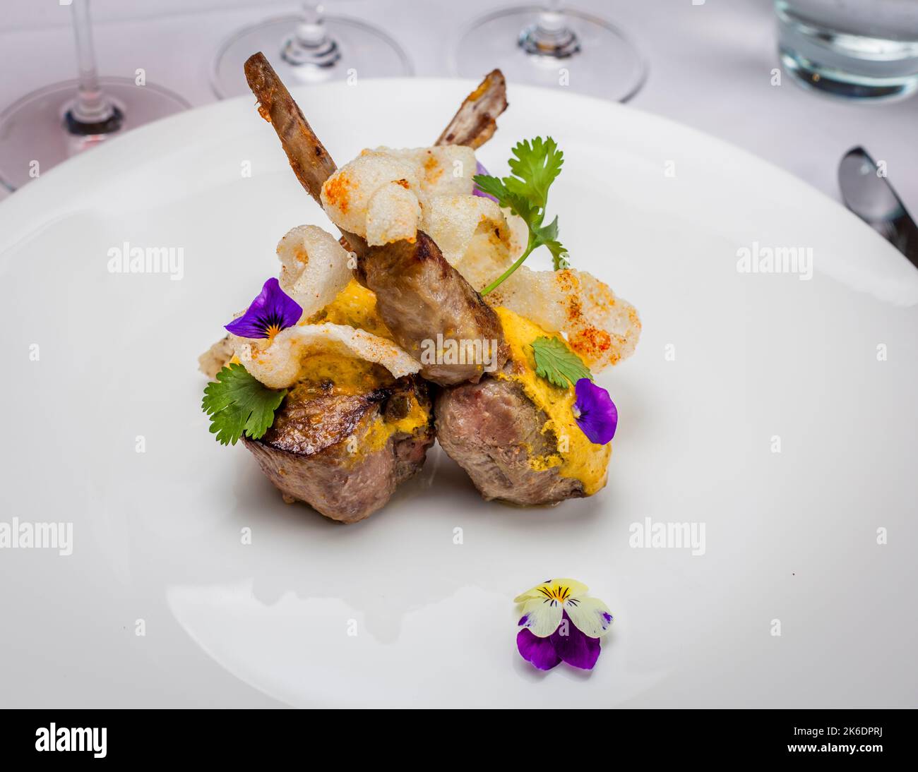 Here, Vineet Bhatia's statement is undoubtedly true: 'Food is becoming lighter and more beautiful'. Lamb chop with rice and mung beans Stock Photo