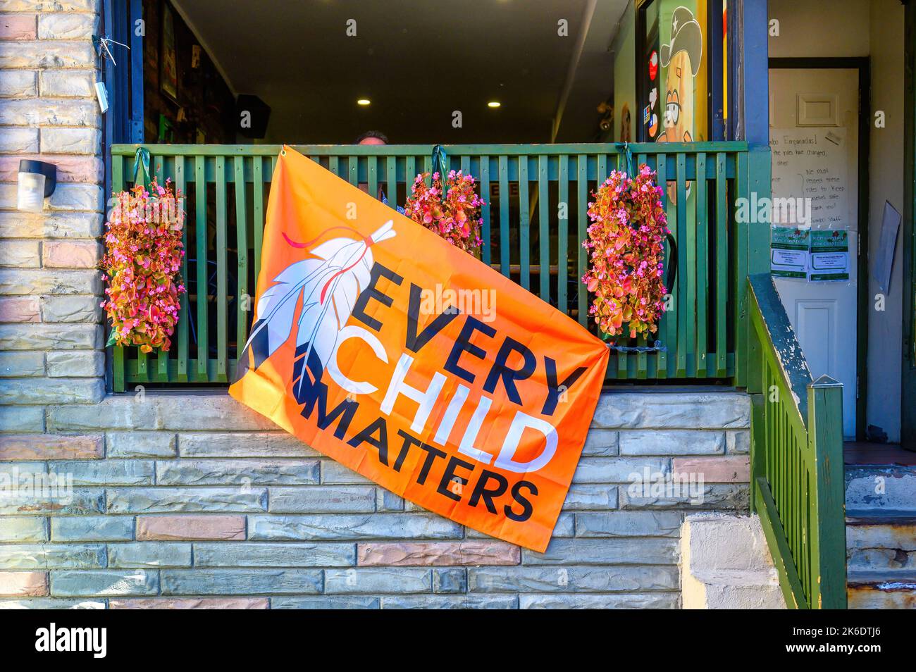 Every Child Matters flag in the railing of a business in Kensingto Market. Stock Photo