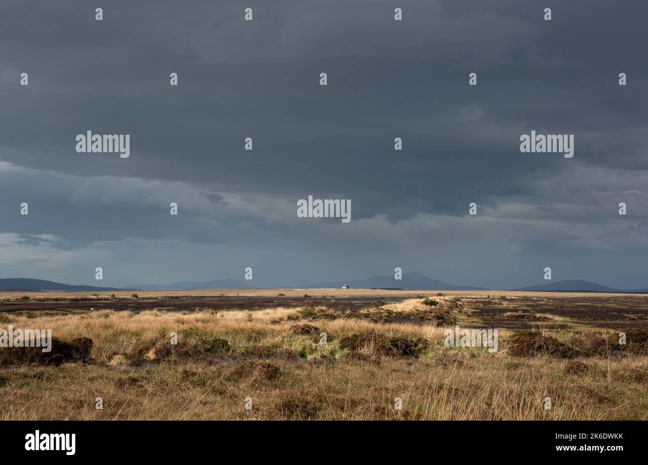 Abandoned cottage in the middle of the vast country of Bangor Erris Bog, County Mayo, Ireland. Dark clouds are gathering, rain is coming. Stock Photo