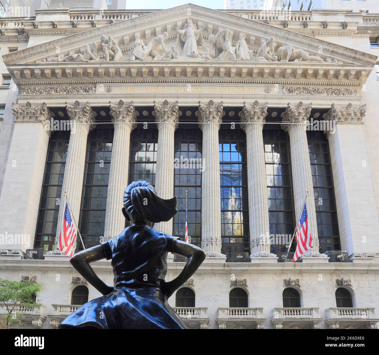 New York Stock Exchange at Wall Street with young girl statue on the foreground, Manhattan. It is the largest stock exchange in the world Stock Photo