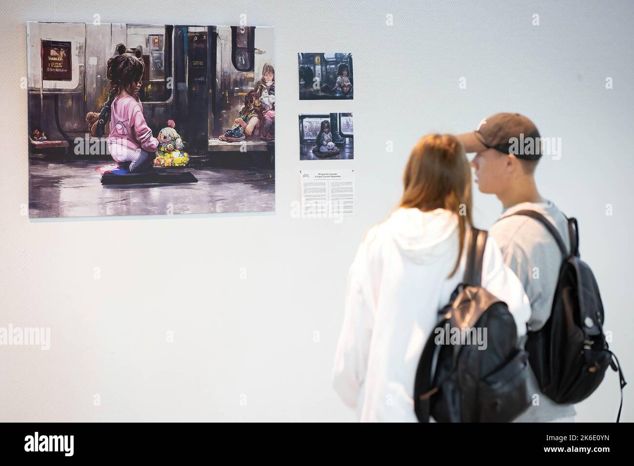 People look at an image generated based on the stories of displaced children during the evacuation from hot spots in the south-east of Ukraine in Kyiv. The exhibition of these pictures is called 'Save Ukr(AI)ne'. On February 2022 Russian troops invaded Ukrainian territory starting a conflict that has provoked destruction and a humanitarian crisis. Stock Photo