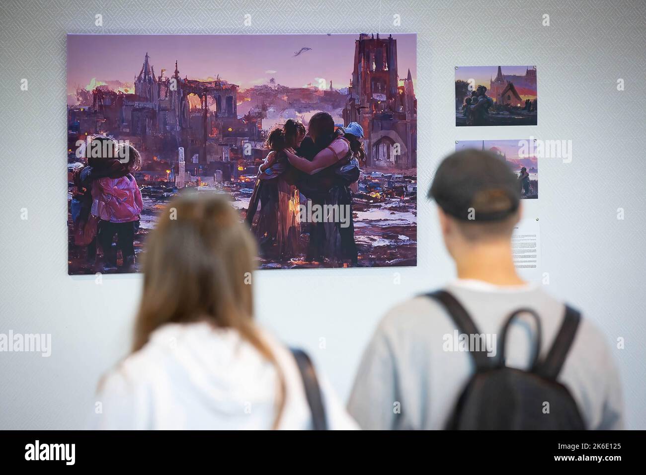 People look at an image generated based on the stories of displaced children during the evacuation from hot spots in the south-east of Ukraine in Kyiv. The exhibition of these pictures is called 'Save Ukr(AI)ne'. On February 2022 Russian troops invaded Ukrainian territory starting a conflict that has provoked destruction and a humanitarian crisis. Stock Photo