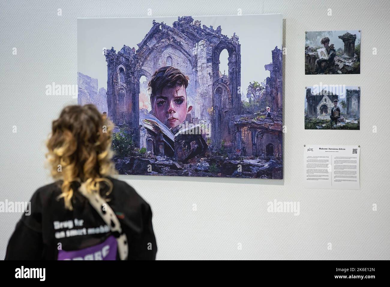 A girl looks at an image generated based on the stories of displaced children during the evacuation from hot spots in the south-east of Ukraine in Kyiv. The exhibition of these pictures is called 'Save Ukr(AI)ne'. On February 2022 Russian troops invaded Ukrainian territory starting a conflict that has provoked destruction and a humanitarian crisis. Stock Photo