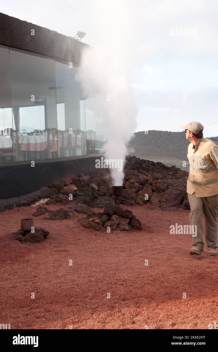 Water steaming due to heat under ground, Timanfaya National Park, Lanzarote, Canary Islands.    The Canary Islands are all volcanic islands (several m Stock Photo