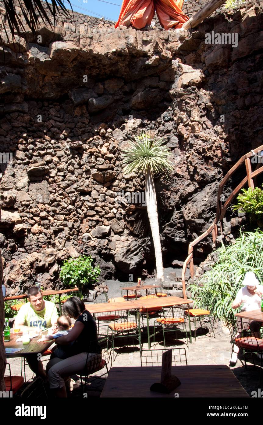 Cafe in collapsed lava tunnel, Jameos del Agua, Lanzarote, Canary Islands.  The Jameos del Agua  is another creation of Cesar Manrique.  The rooves of Stock Photo