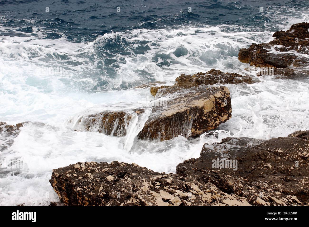 Coast rocks splashed by sea waves Stock Photo