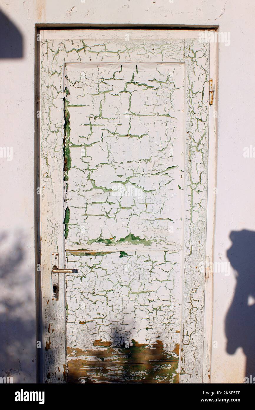 Old wooden door with cracking white paint Stock Photo Alamy