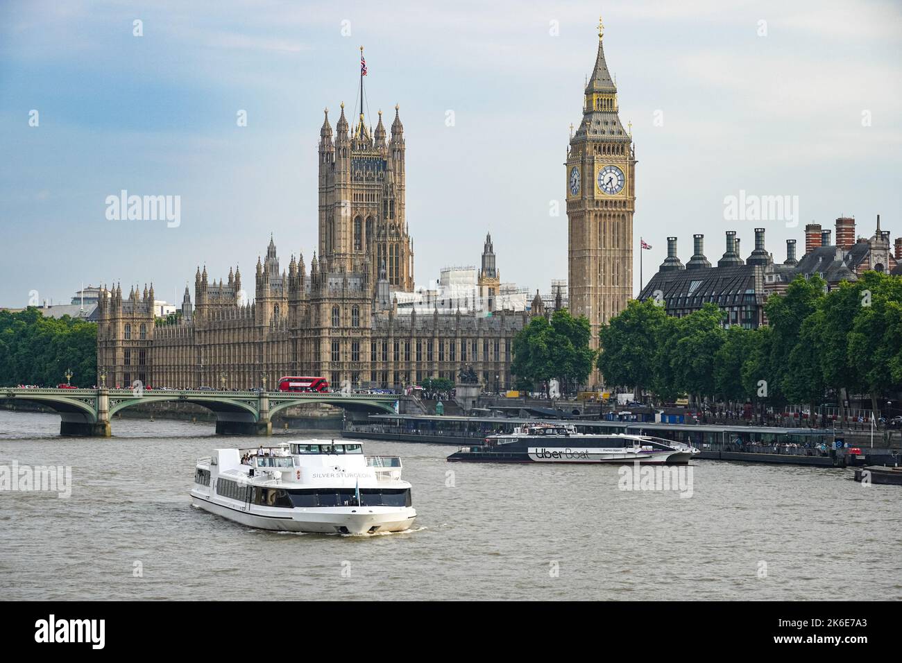Cruise boats on the River Thames with Westminster Bridge, the Big Ben clock tower and the Palace of Westminster, London England United Kingdom UK Stock Photo