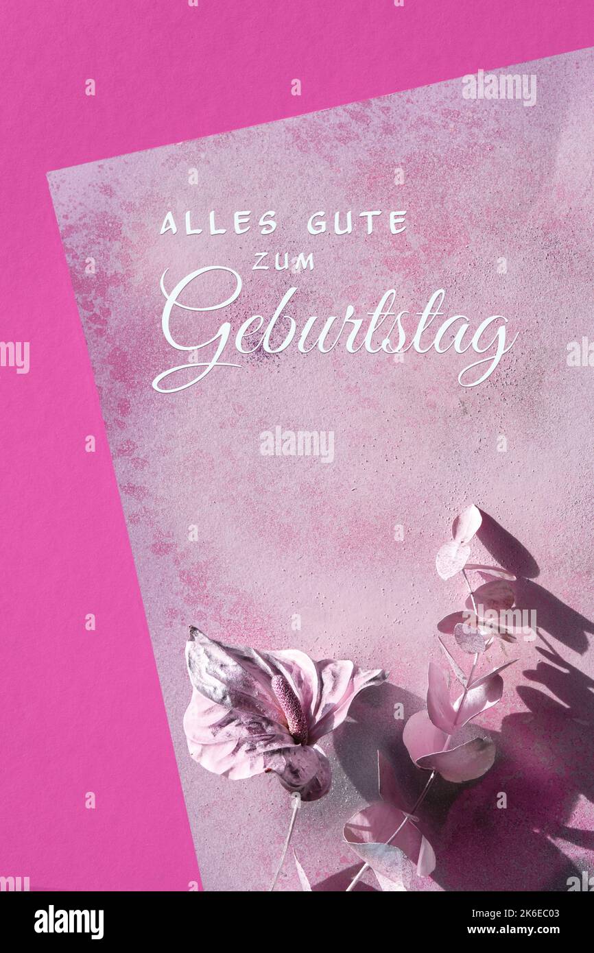 Greeting text Alles Gute zum Geburtstag means Happy Birthday in German language. Abstract flat lay with dry cala lily flower and eucalyptus twig Stock Photo