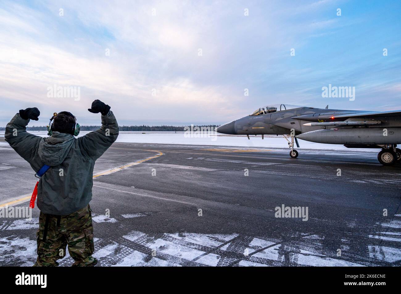 U.S. Air Force Airman 1st Class Kyle Netanel, 44th Aircraft Maintenance Unit crew chief, sends off an F-15C/D Eagle during RED FLAG-Alaska (RF-A) 23-1 at Eielson Air Force Base, Alaska, Oct. 12, 2022. RF-A is a two-week advanced aerial combat training exercise that aims to offer realistic air-combat training for military pilots and other flight crew members from the United States and allied countries. (U.S. Air Force photo by Senior Airman David Phaff) Stock Photo