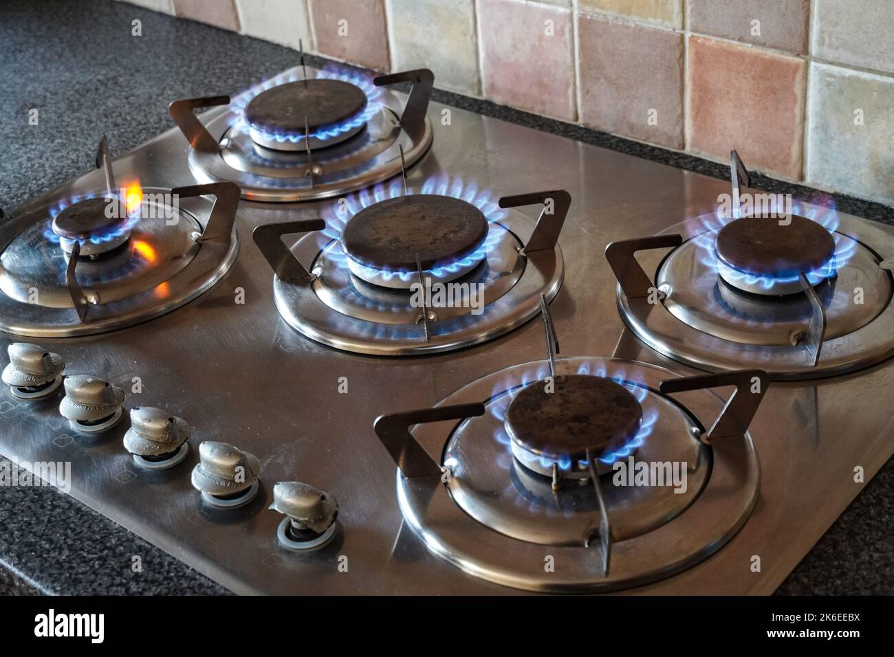 Blue gas flames burning on a gas hob burner, kitchen gas cooker Stock