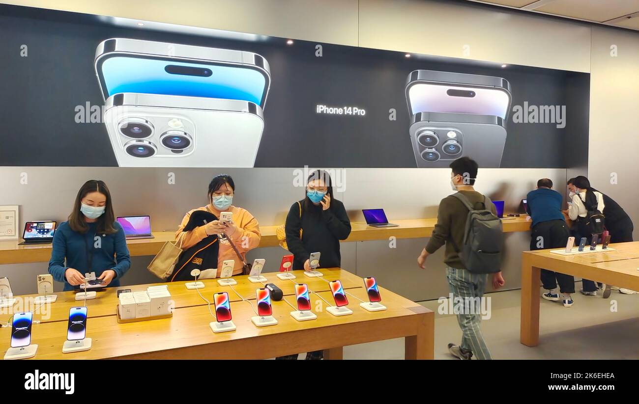 SHANGHAI, CHINA - OCTOBER 13, 2022 - Customers experience the new iPhone 14 series smartphones at the Apple Inc flagship store in Shanghai, China, Oct Stock Photo