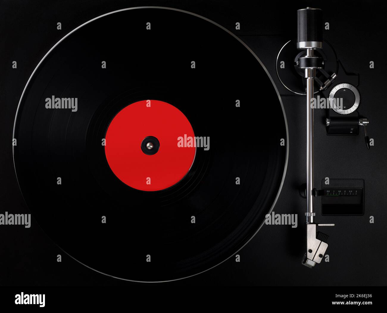 Black turntable playing vinyl record, blank label. Top view of old fashioned turntable. Stock Photo