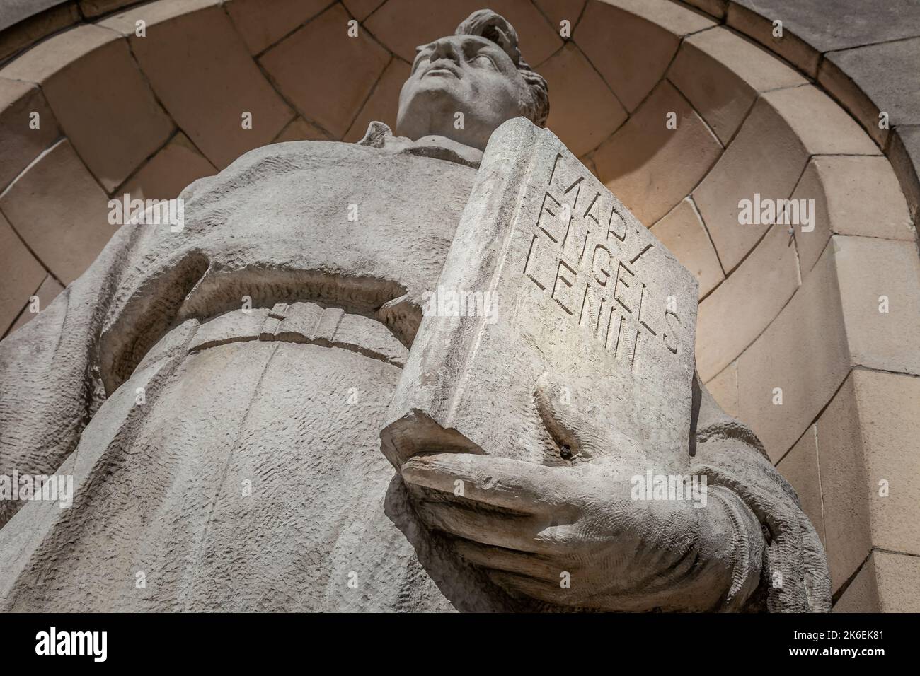 Worker with Marx, Engels and Lenin book in Warsaw, Poland Stock Photo