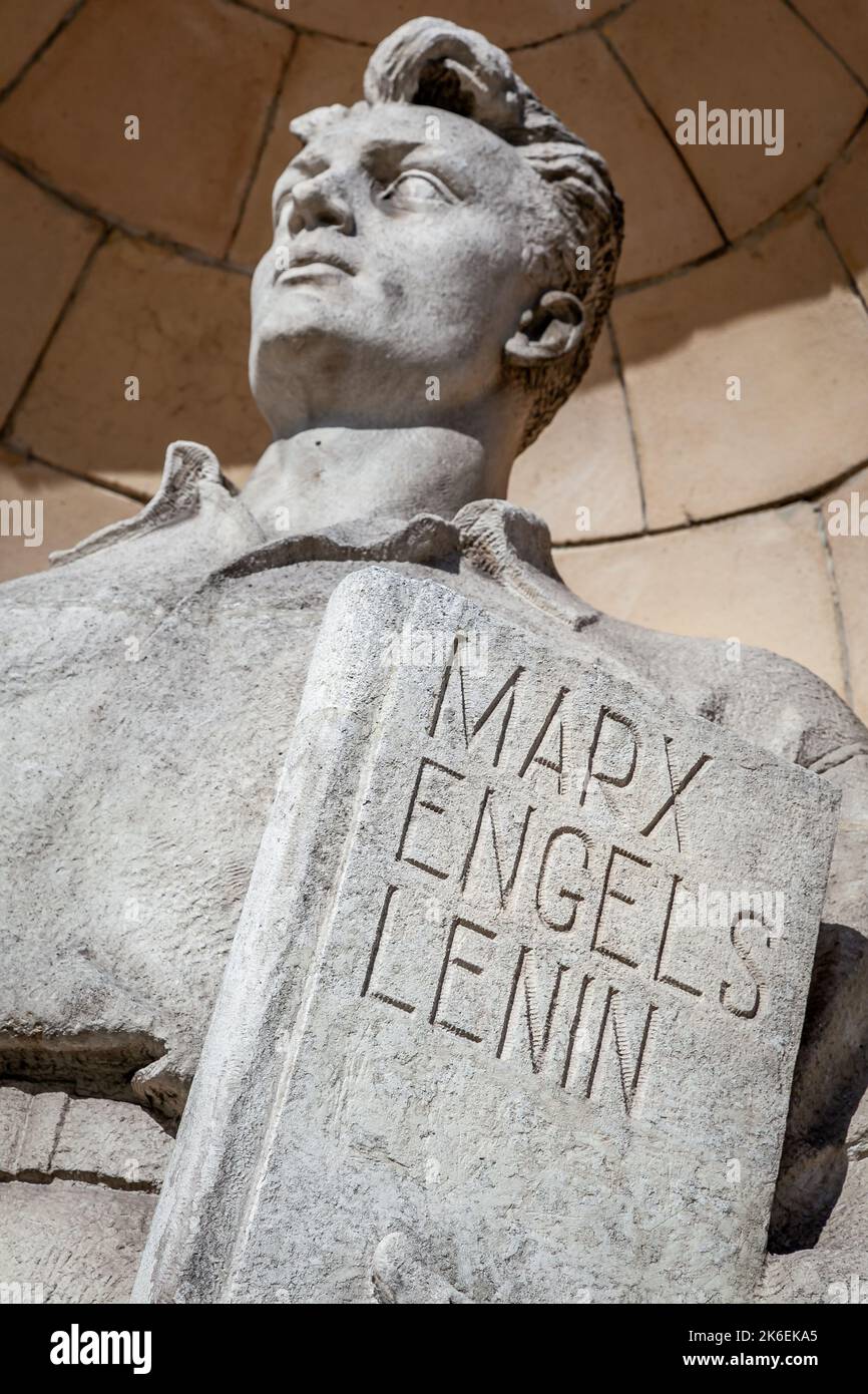 Worker with Marx, Engels and Lenin book in Warsaw, Poland Stock Photo