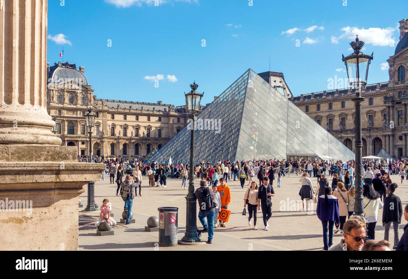 People congregate around the Louvre Pyramid, Paris, France Stock Photo
