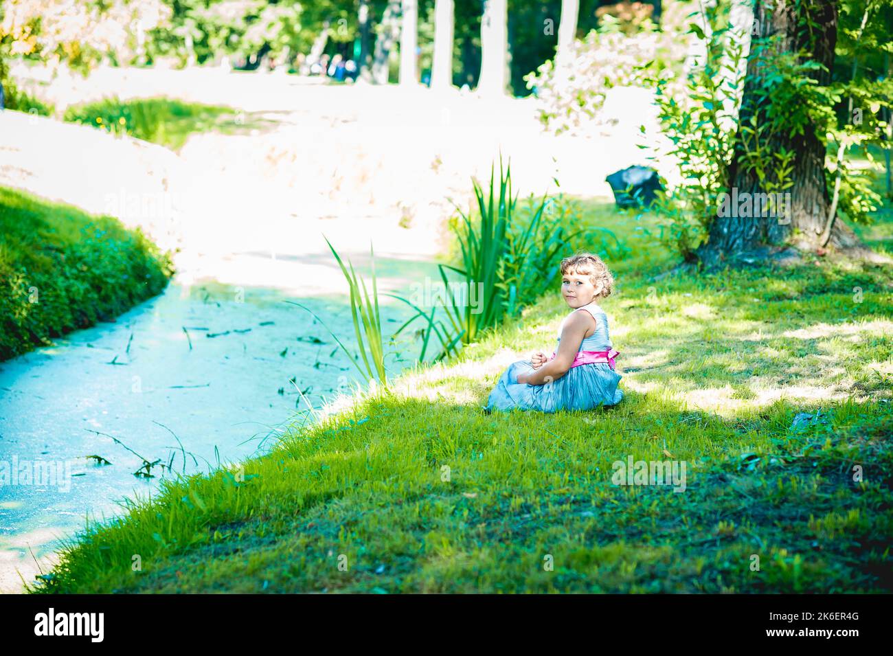 Happy little girl in the park Stock Photo - Alamy