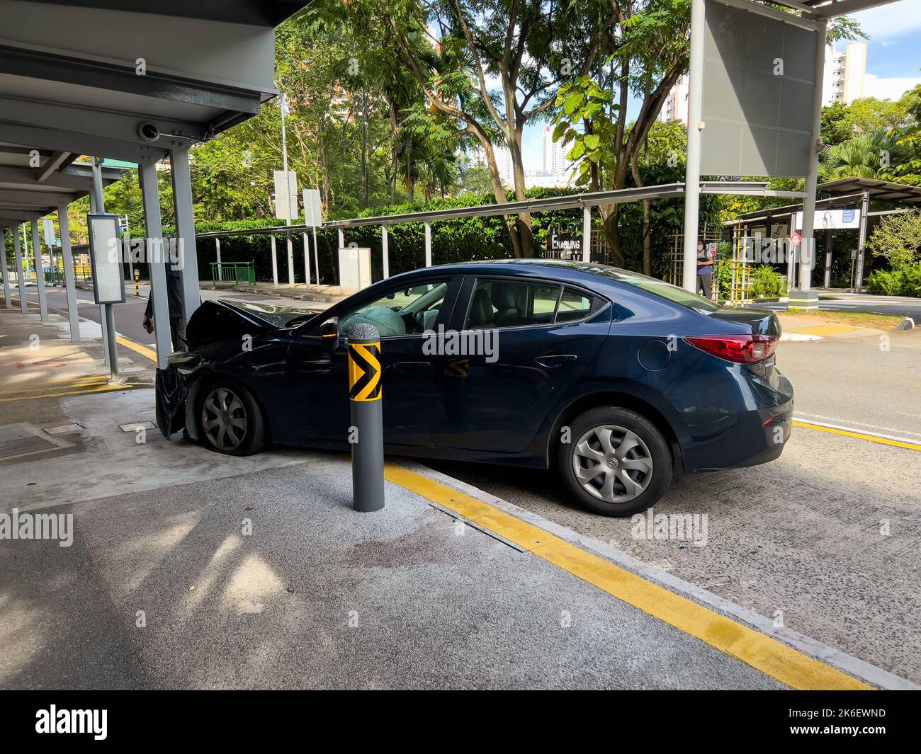 Punctured left tire on the front car vehicle crash onto a pillar, front bonnet badly dented, air bag inside the driver seat is activated. Reckless Stock Photo