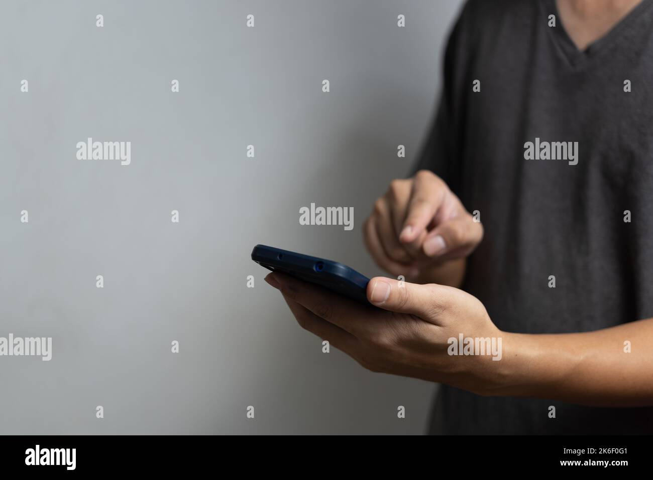 Man hand holding mobile smart phone technology communication digital. Stock Photo