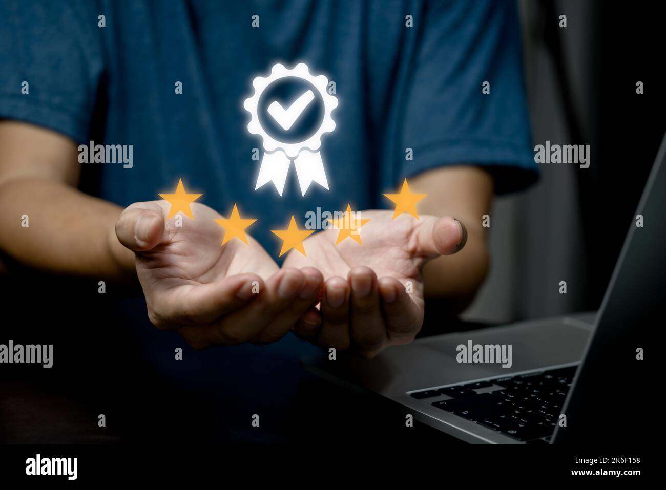 Businessman holding and showing the best Quality assurance service guaranteed, business success work efficiency top 5 stars concept. Stock Photo