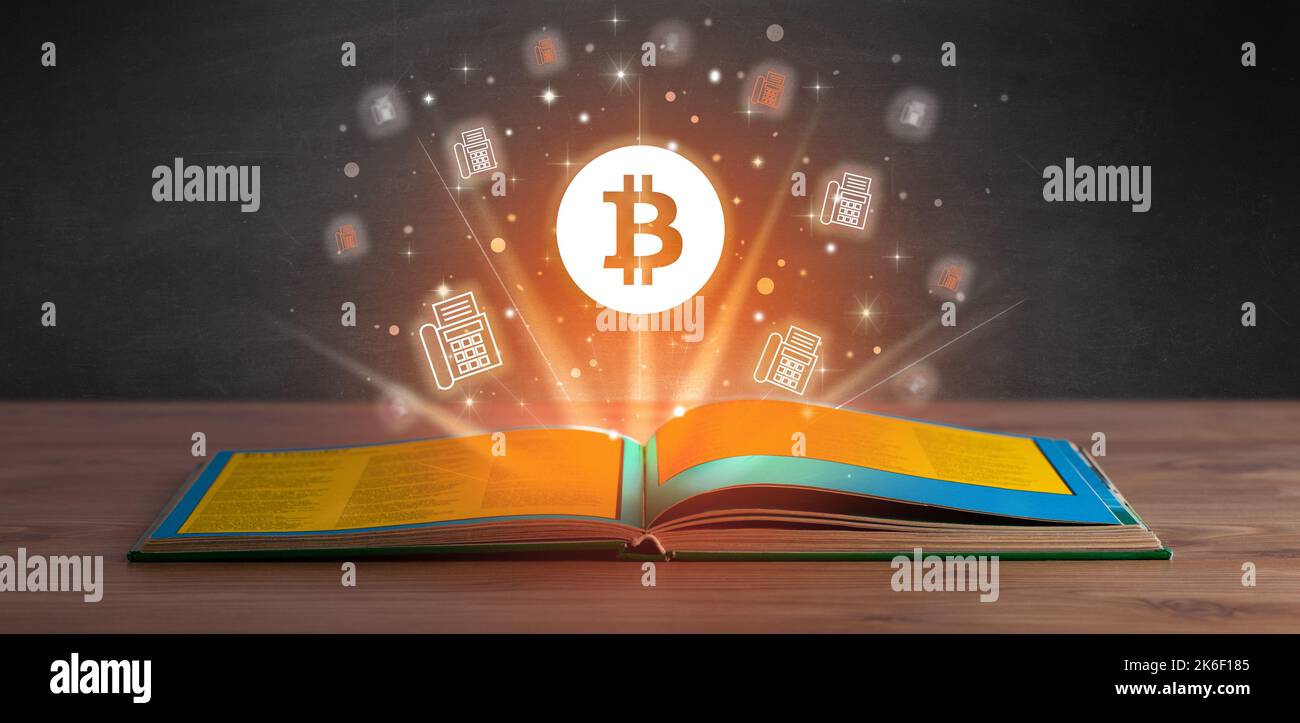Open book with currency icons above Stock Photo - Alamy