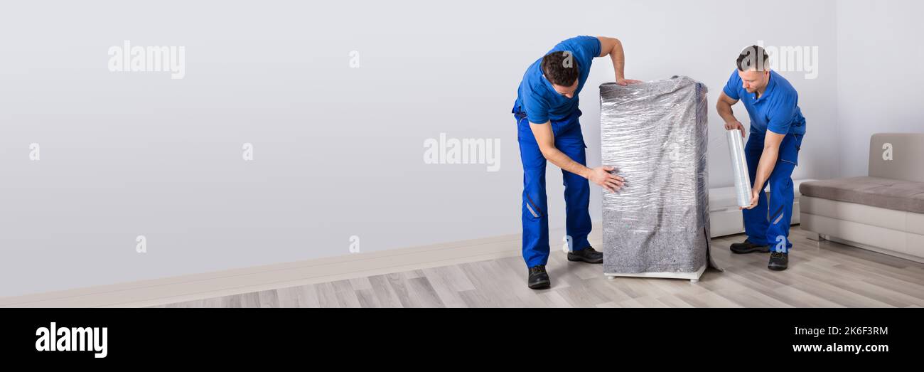 Professional Furniture Movers Wrapping. House Packing Service Stock