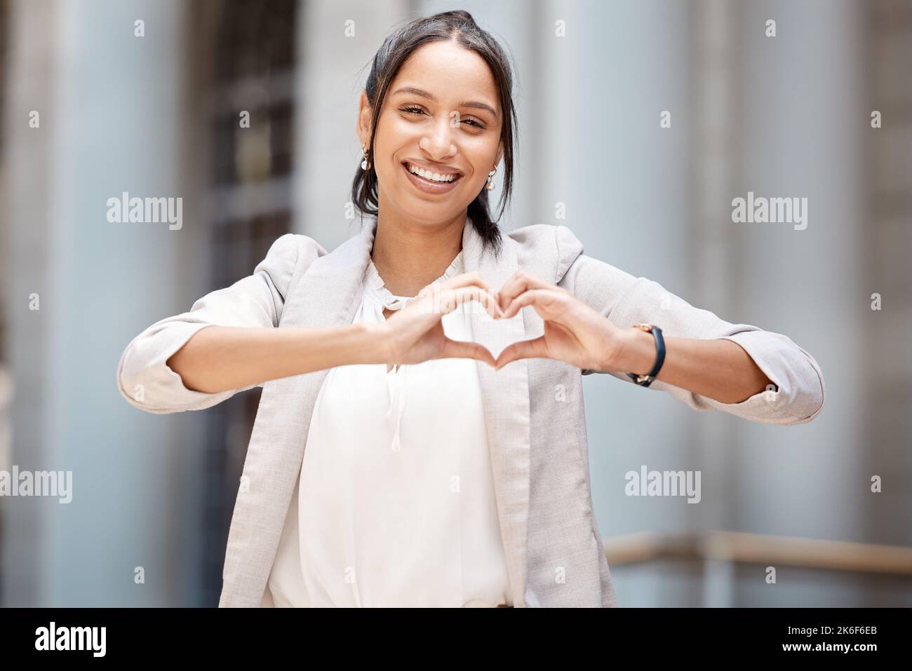 Heart, hands sign and city girl with love emoji icon, gesture or symbol for happiness or self care. Portrait smile of black woman or happy business Stock Photo