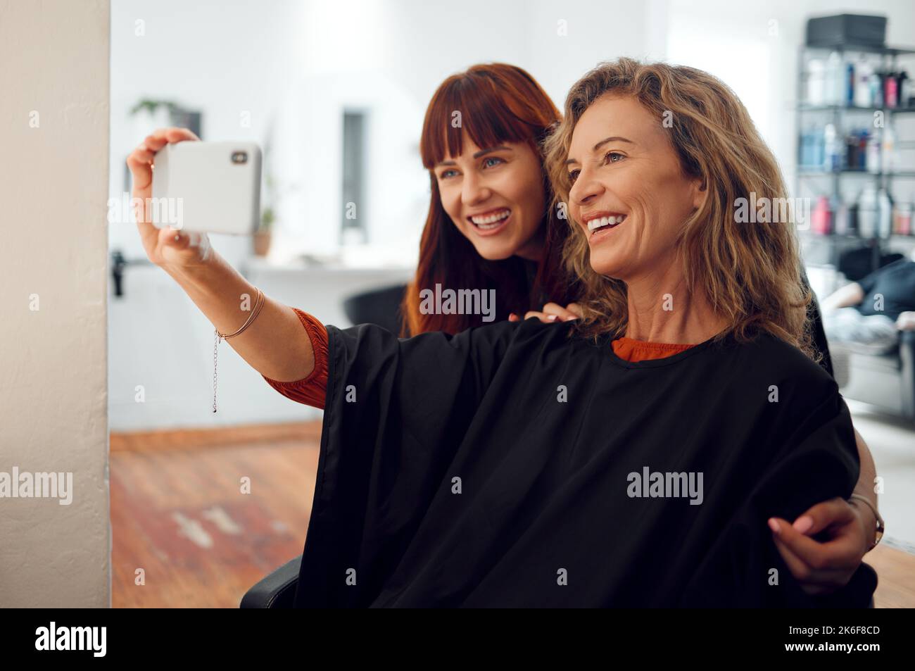 Selfie, women and designer hairdresser spa hair care day at salon studio. Beauty, senior customer and young hair stylist take photograph on mobile Stock Photo