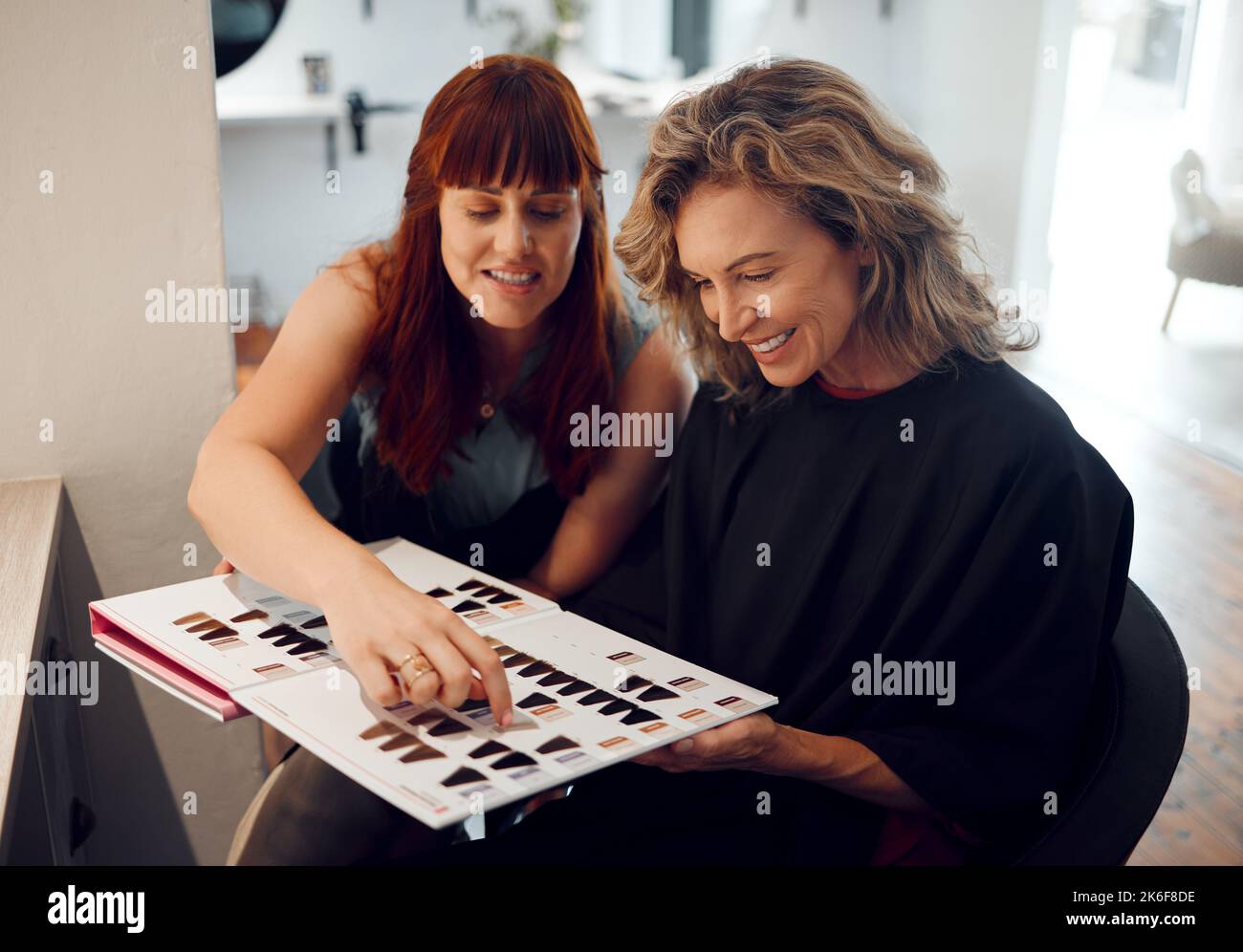 Hair salon, color catalog and consultation with woman client consultation, decision and planning advice with professional stylist in hairdresser Stock Photo