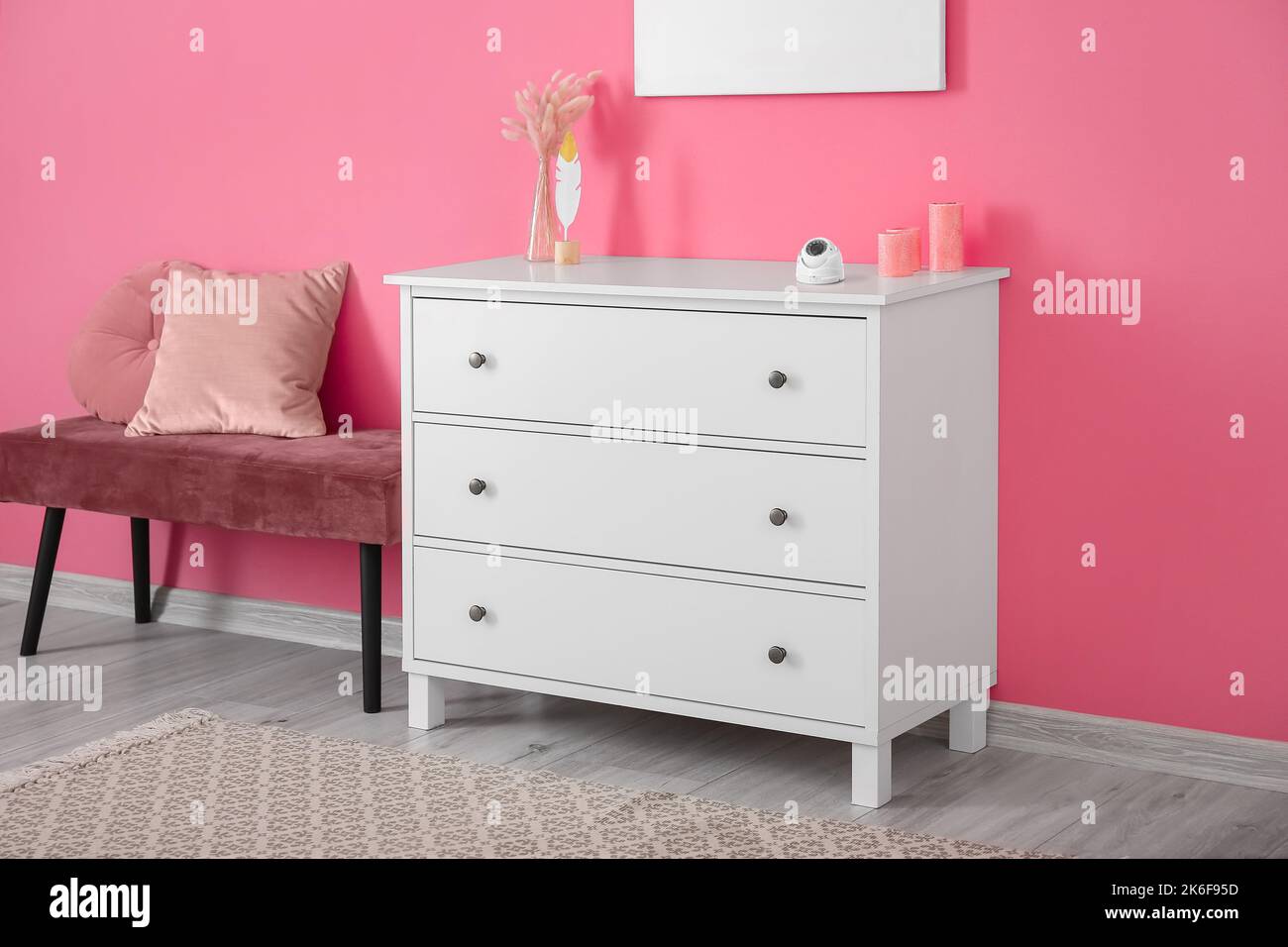 Modern security CCTV camera on chest of drawers at home Stock Photo