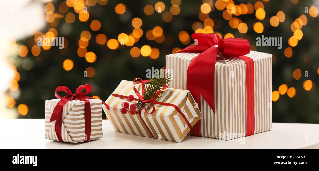 Christmas gifts on table in room Stock Photo - Alamy