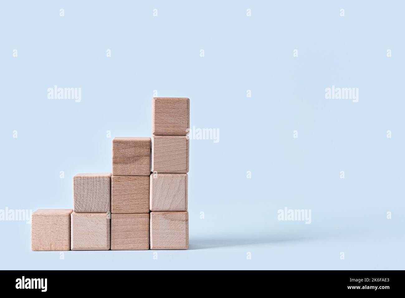 Ladder made of wooden blocks on light background Stock Photo - Alamy