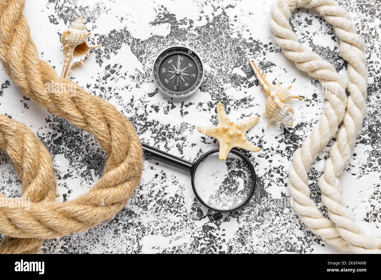 Magnifier, compass, ropes and seashells on grunge background Stock Photo