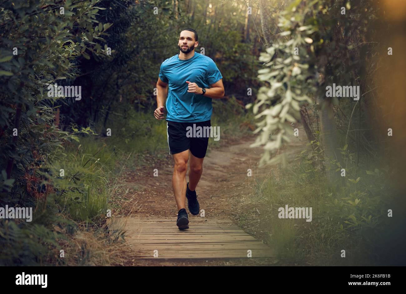 Fitness, man and running in nature for healthy exercise, training and workout in the outdoors