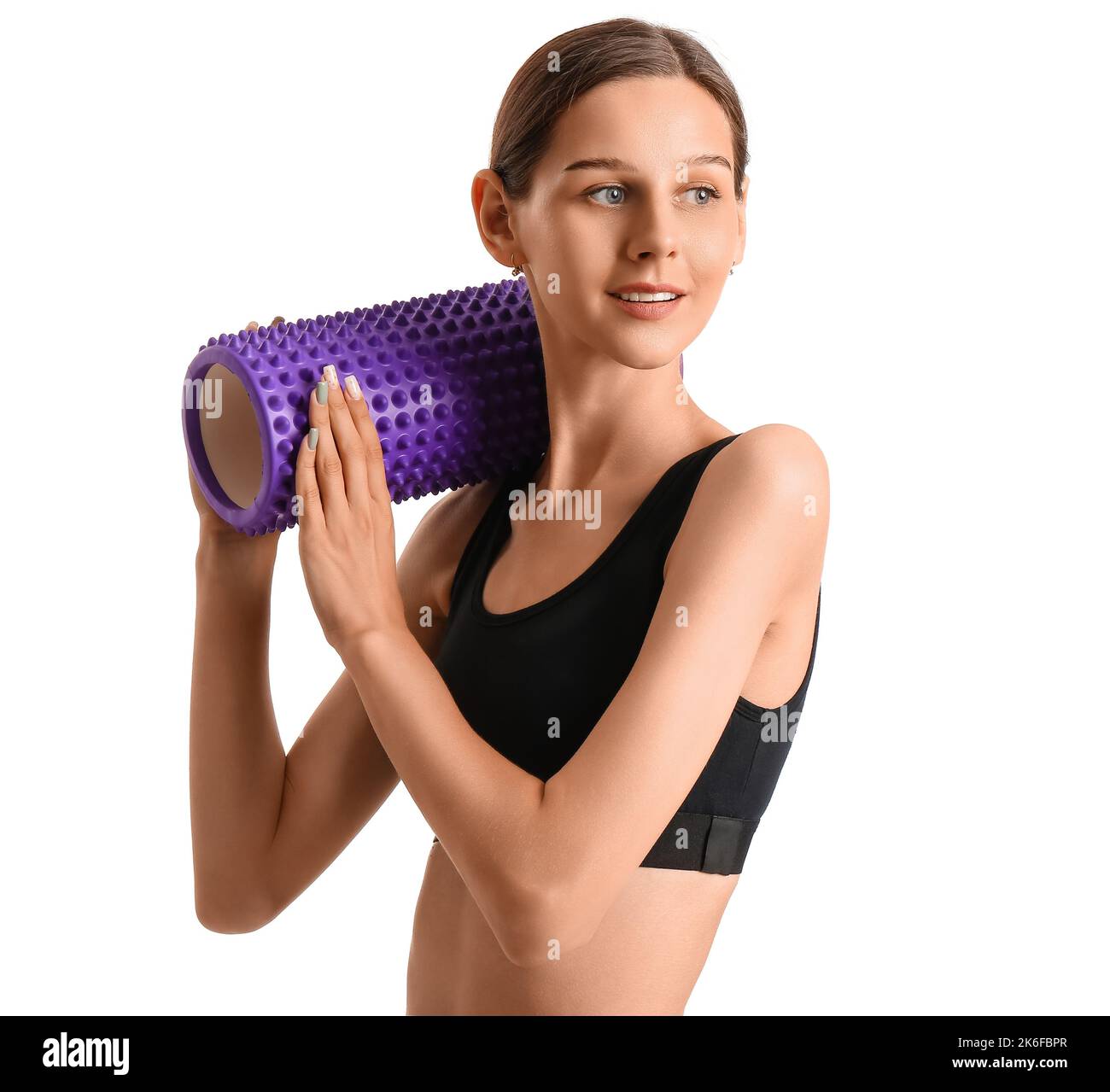 Sporty young woman with foam roller on white background Stock Photo - Alamy