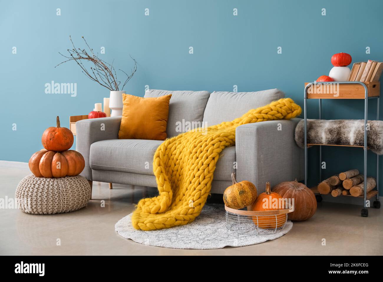 Interior of cozy living room with pumpkins, sofa and pouf Stock Photo ...