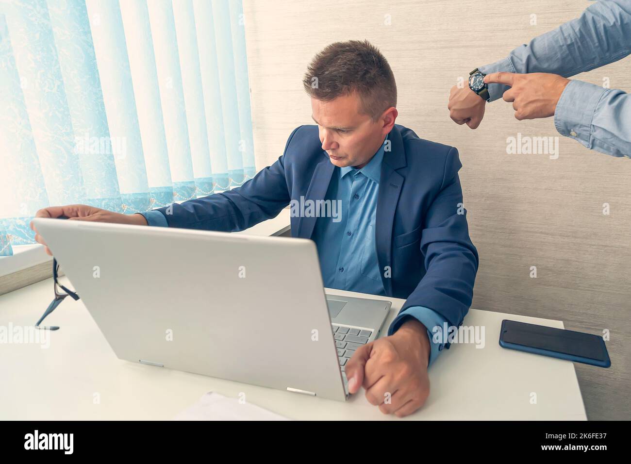 Keep track of time. man point at clock. Work time or working hours