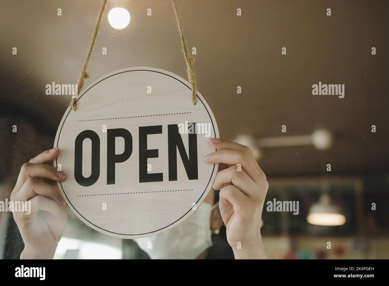 waitress staff woman wearing protection face mask turning Open sign ...