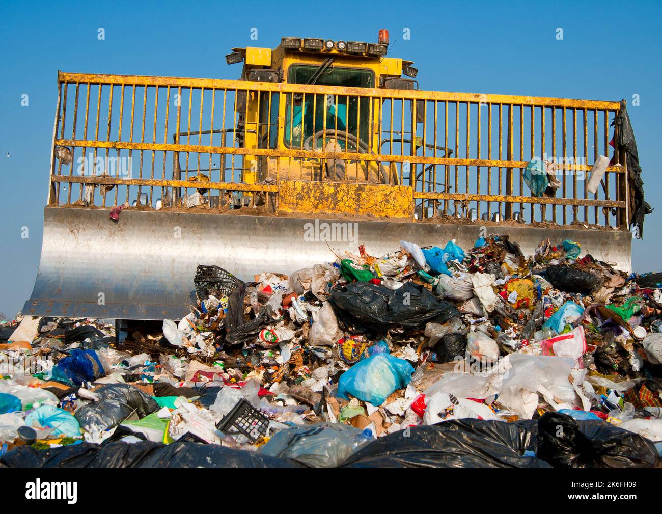 Municipal waste landfill. Workers with trucks and bulldozers at work in