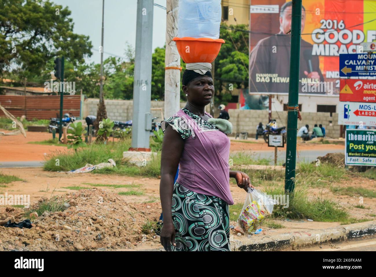 Accra, Ghana - April 06, 2022: Local African Street Woman Seller on the  Accra street Stock Photo