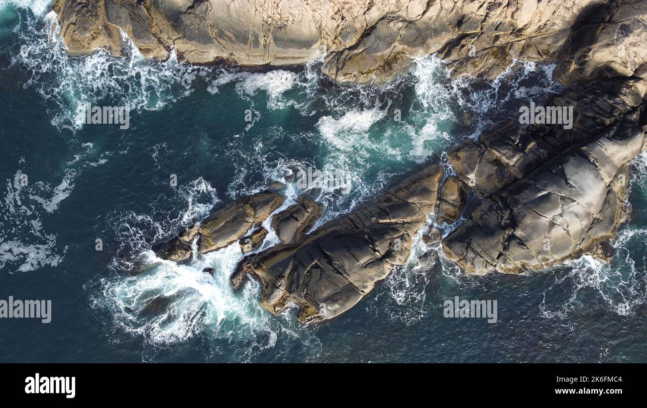 An aerial view of sea waves breaking rocky beach Stock Photo - Alamy