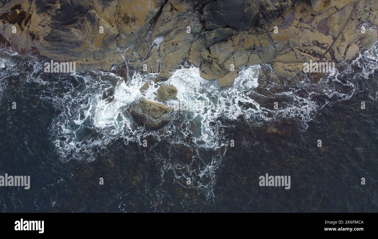 An aerial view of sea waves breaking rocky beach Stock Photo - Alamy