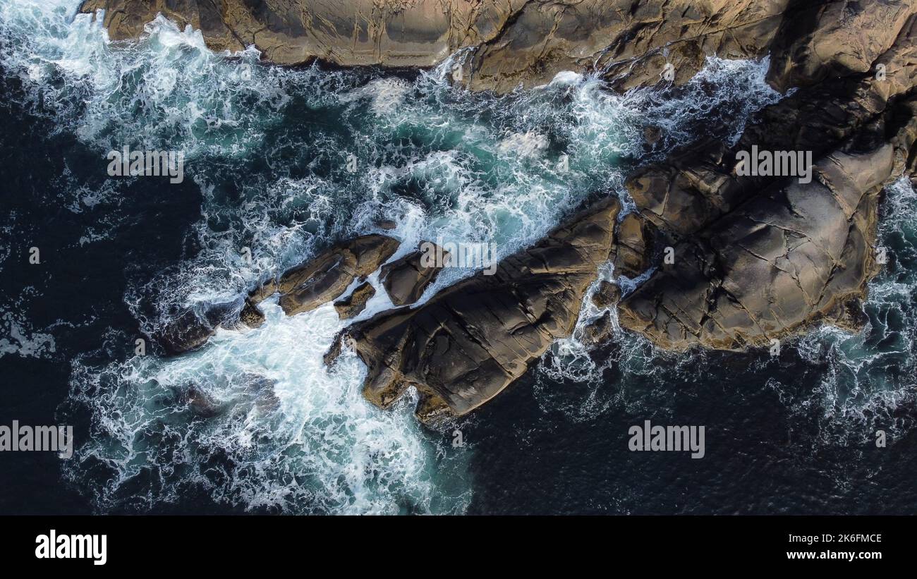 An aerial view of sea waves breaking rocky beach Stock Photo - Alamy
