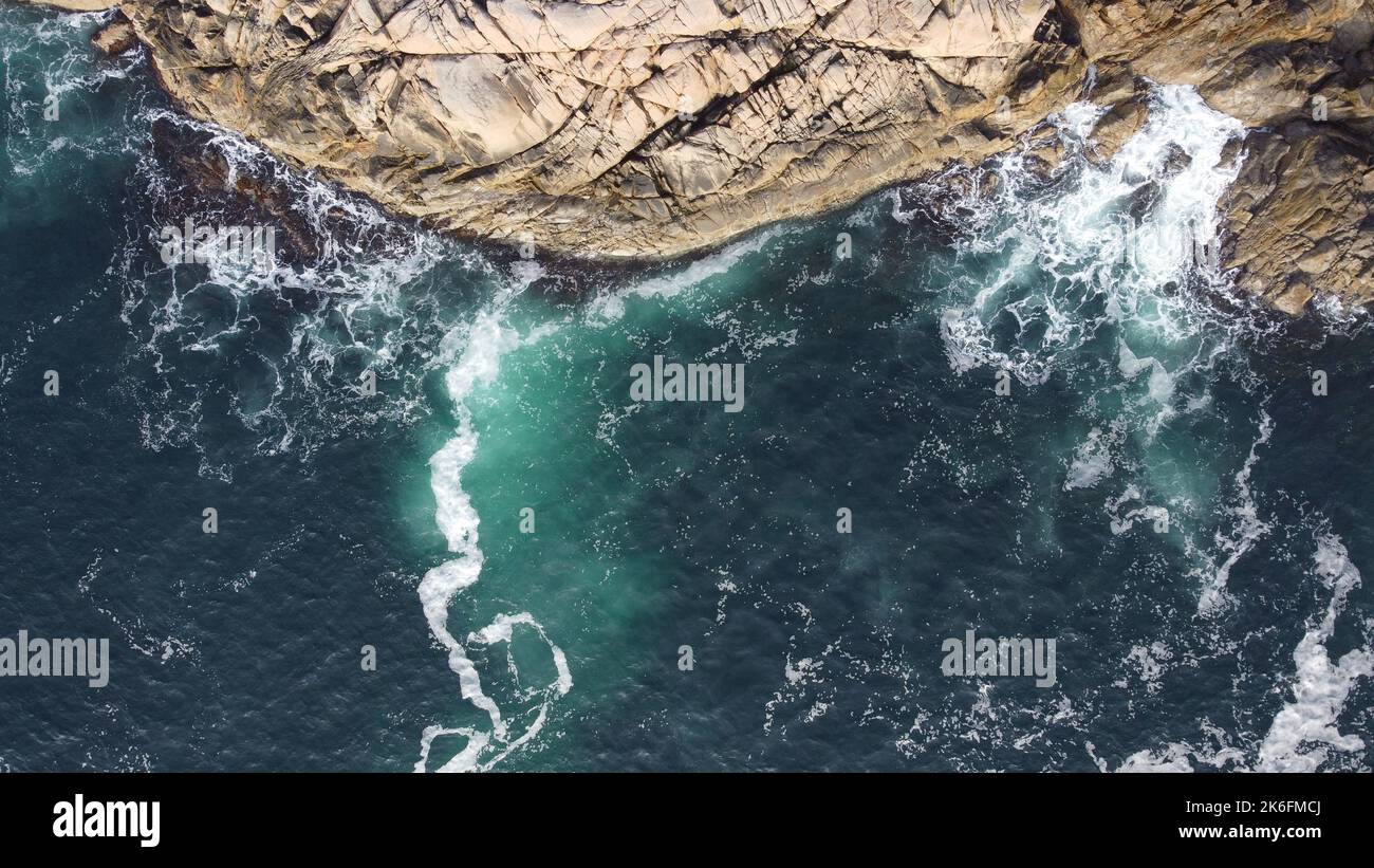 An aerial view of sea waves breaking rocky beach Stock Photo - Alamy