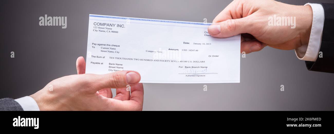 Paying Staff With Check. Salary Payroll Cheque Stock Photo - Alamy